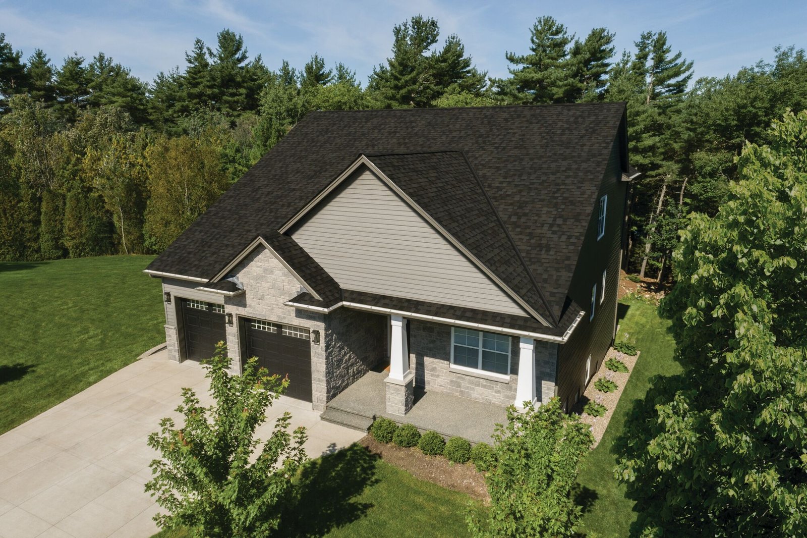 Experienced roofer inspecting roof decking and underlayment during a full replacement project