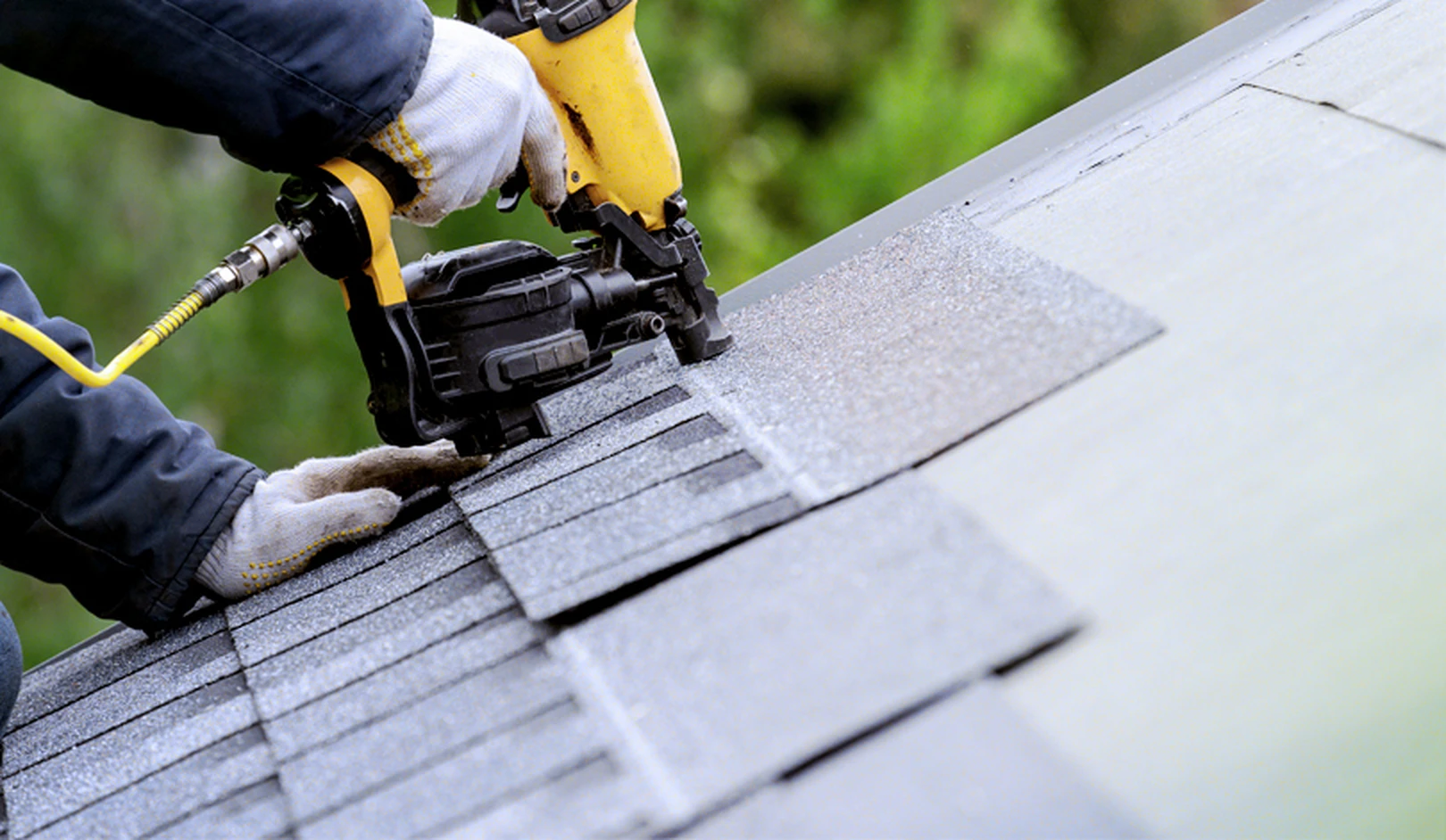 Crew replacing worn shingles on a single-story home in an active retirement neighborhood